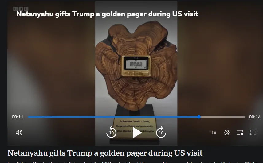 A golden pager is embedded in a wooden base shaped like a heart, with a plaque reading 'To President Donald J. Trump, Our…