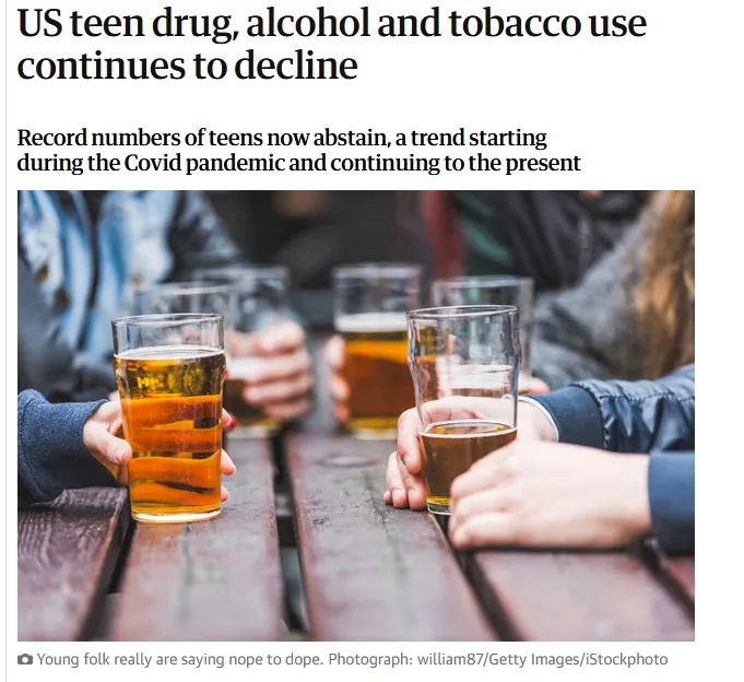 The image shows several young people holding glasses of beer at a wooden picnic table, visually contradicting the headline…