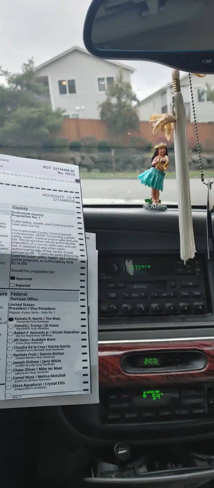 A close-up shot from inside a car shows a ballot for Snohomish County Proposition No. 1 and the U.S. presidential election…