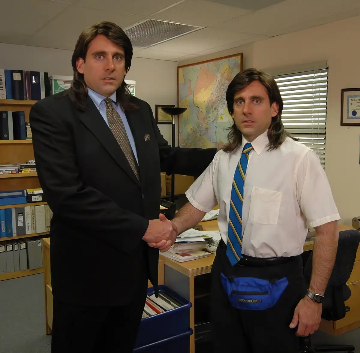 Two identical men, both with long brown hair and wide-eyed expressions, stand in an office shaking hands. One wears a black…