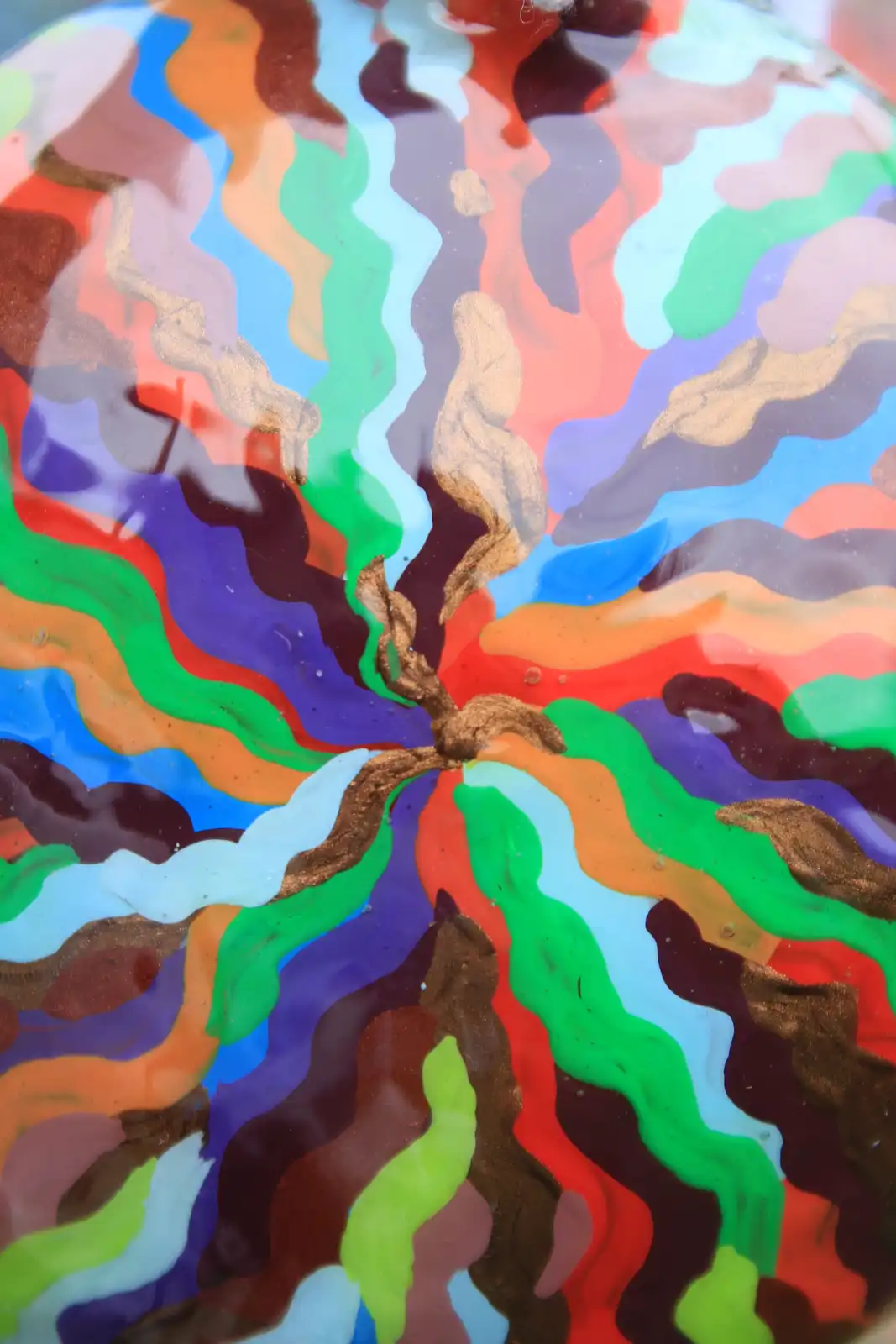 A close-up of a colorful, abstract, swirling pattern resembling a brain with wavy lines of red, blue, green, orange, purple…