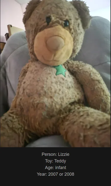 A close-up photo of a worn, brown teddy bear with a green star-shaped tag on its chest, sitting on a gray couch. The bear…