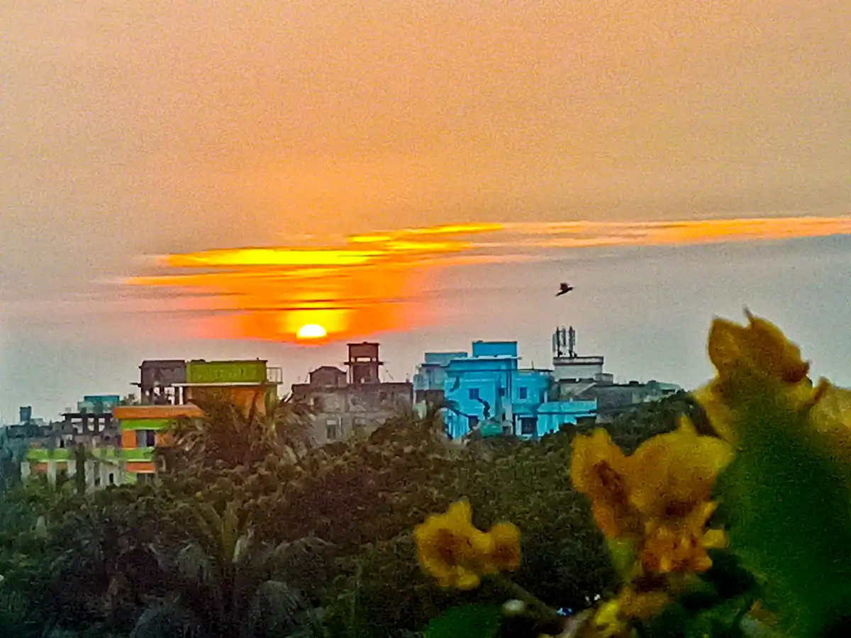 A scenic photo of a sunset over a cityscape with colorful buildings and trees in the foreground, overlaid with the text 'i'm…