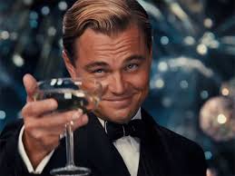 leonardo dicaprio in a tuxedo holding a champagne glass with a smug smile, overlaid with the text 'you're not a real man…