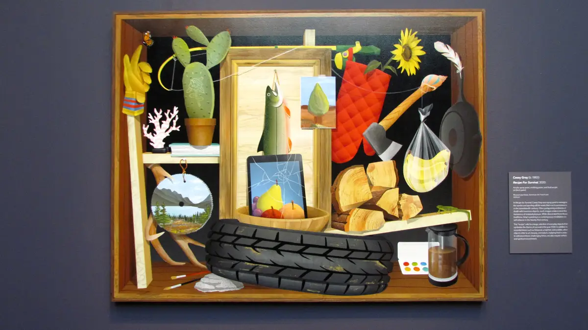 A colorful, surreal diorama artwork titled 'Recipe For Survival' by Casey Gray (2020) depicts a wooden box filled with…