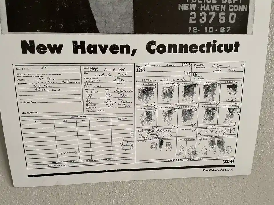 A black-and-white police arrest record from New Haven, Connecticut, dated December 10, 1967, for James Morrison. The form…