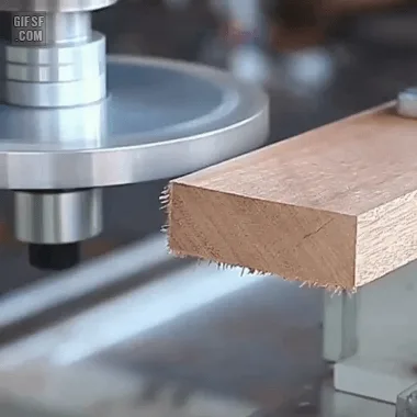 A six-panel sequence shows a CNC machine precisely cutting and drilling a wooden block, starting with a flat piece, then…