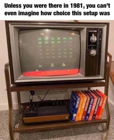 An old-fashioned CRT television displaying the arcade game 'Space Invaders' with green aliens and a red player ship. Below…