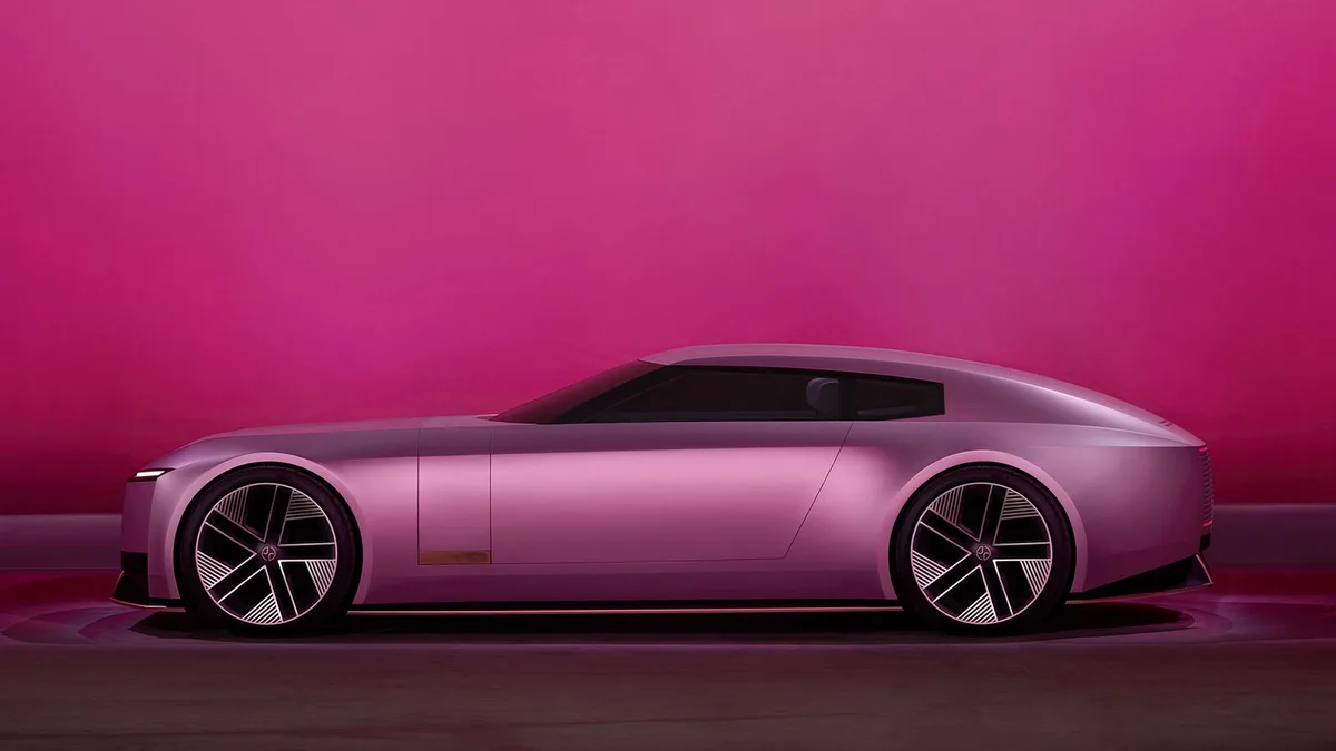 a sleek, futuristic-looking car with a metallic purple finish is shown in profile against a solid pink background. The car…