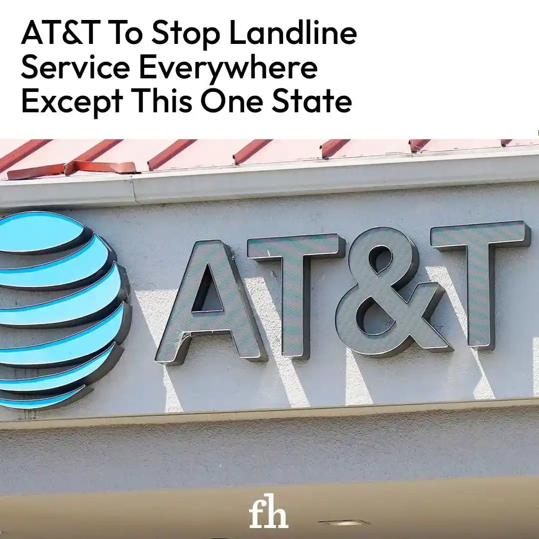 An outdoor photo shows the AT&T logo and company name in large, metallic letters mounted on a building facade. The logo is a…