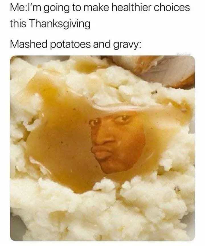 A close-up photo of mashed potatoes with gravy pooled on top, where the gravy forms a clear, distorted reflection of a man's…