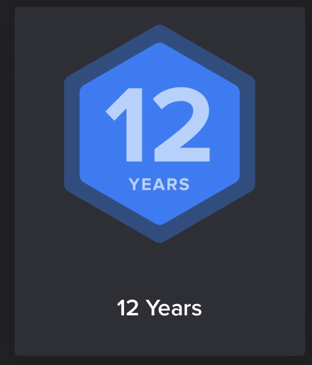 A dark gray background features a blue hexagonal badge with the number '12' and the word 'YEARS' in white text inside. Below…
