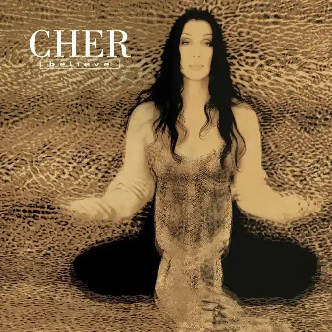 The image is the album cover for Cher's 2001 album 'Believe', showing Cher sitting cross-legged on a leopard-print surface…
