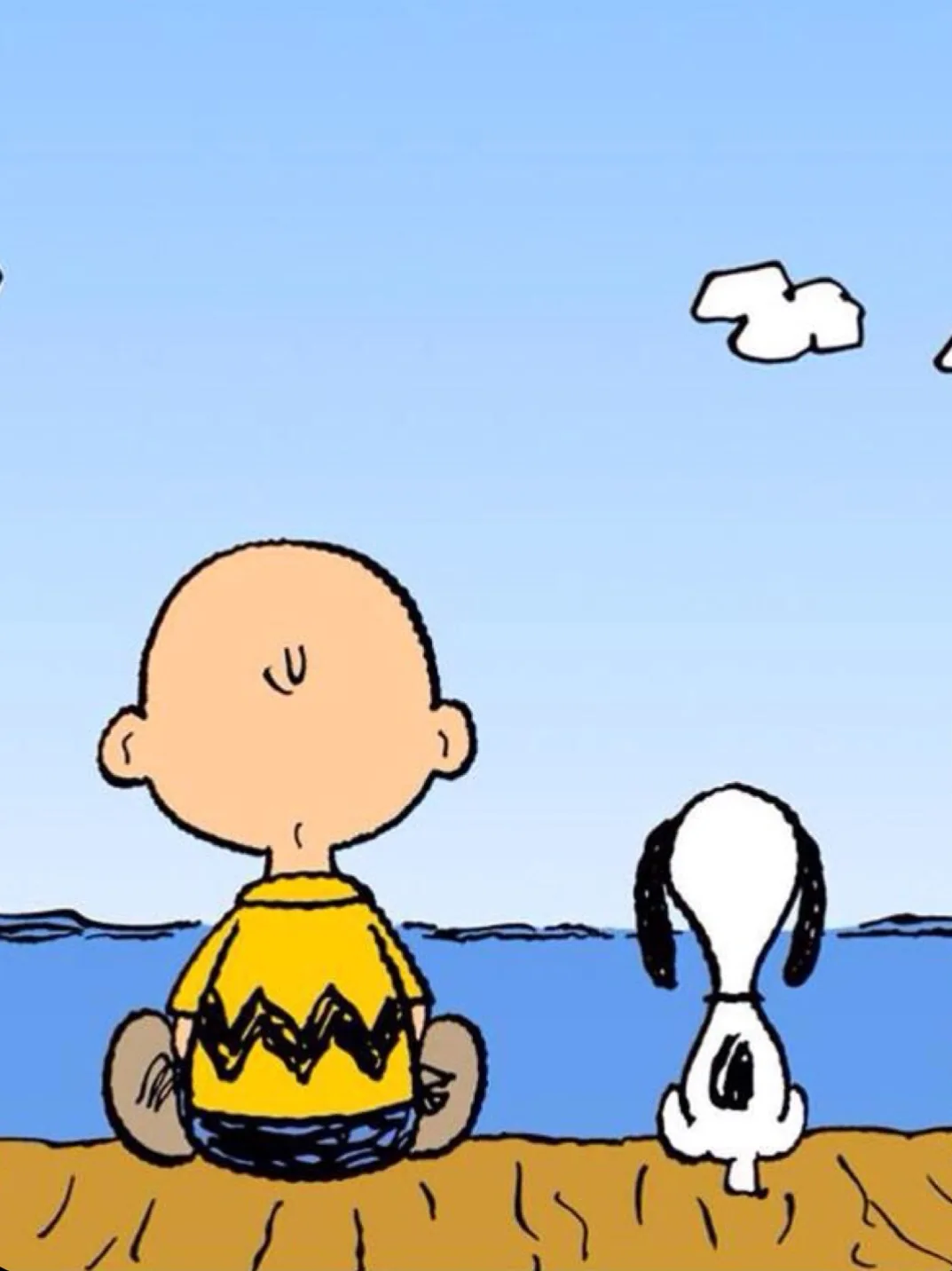 A cartoon image shows Charlie Brown in a yellow shirt and Snoopy sitting side-by-side on a sandy beach, both facing away…