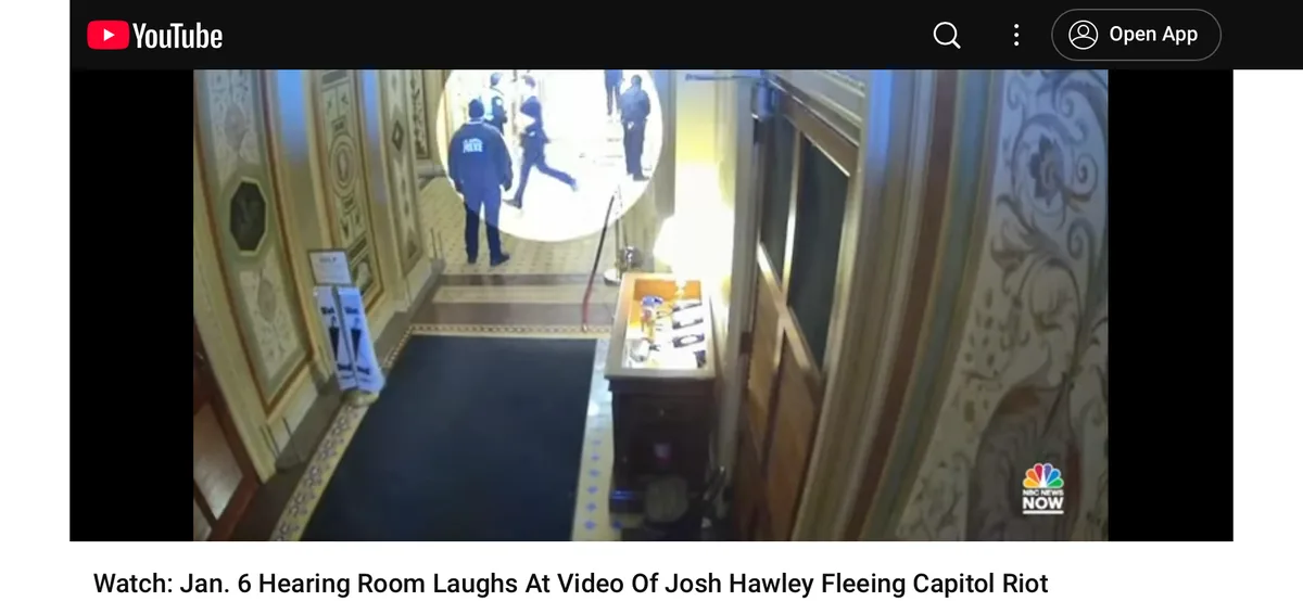 A security camera view shows a hallway with ornate walls and a black rug, where several people in dark clothing are seen…