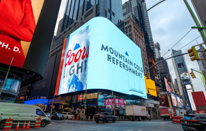 A large digital billboard in Times Square displays the Coors Light logo alongside the slogan 'MOUNTAIN COLD REFRESHERMENT'…