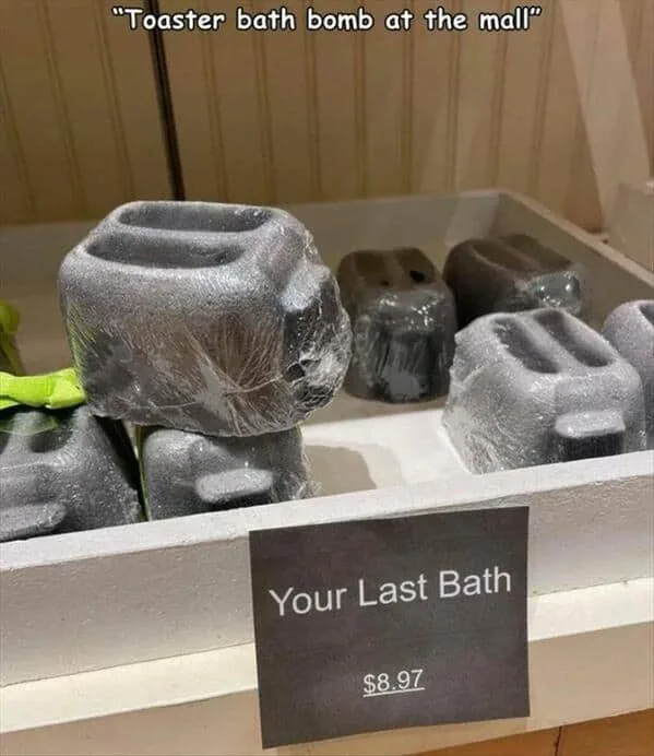 A display of bath bombs shaped like toasters, wrapped in plastic, with a price tag reading 'Your Last Bath $8.97'. The image…