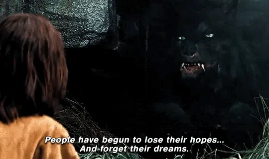 A still from the movie 'The Twilight Saga: Eclipse' shows a young woman in an orange sweater facing a menacing black…
