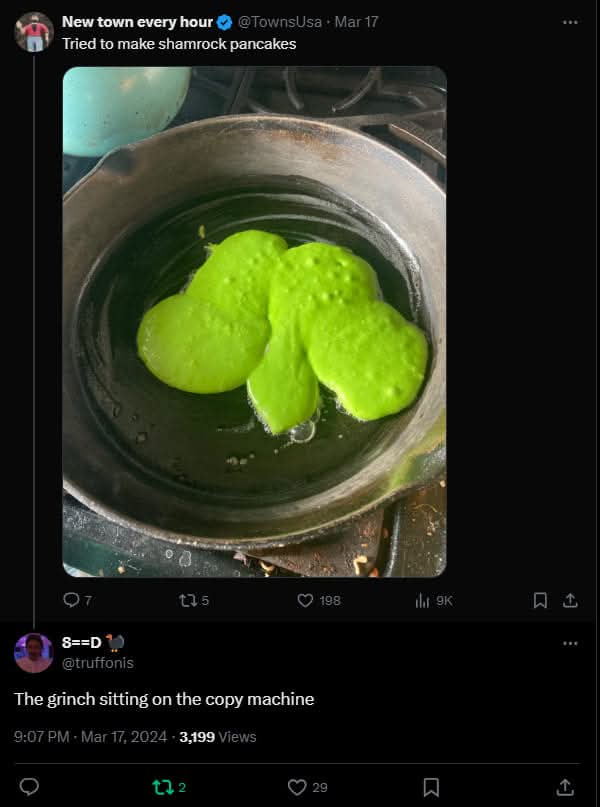 A close-up photo shows three bright green, lumpy pancake batter blobs cooking in a black skillet on a stovetop. The original…