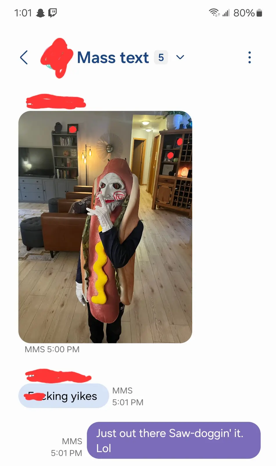 A person in a hot dog costume with a Jigsaw mask from Saw is shown in a living room. The image is part of a text message…