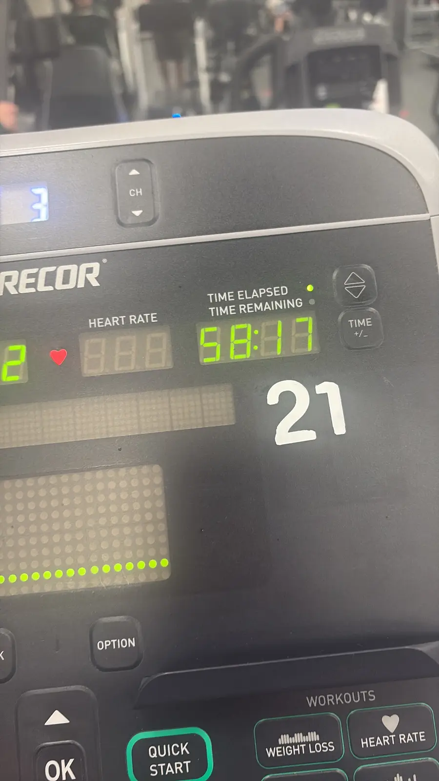 A close-up of a Recor exercise machine's digital display showing a heart rate of 2 with a red heart icon, time remaining of…