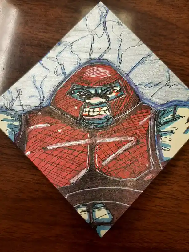 A hand-drawn, diamond-shaped illustration on paper depicts a cartoonish, angry red-faced character with a blue mask, bared…