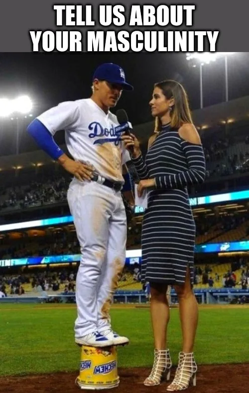 A baseball player in a Dodgers uniform stands on a yellow Red Bull can while being interviewed by a woman holding a…