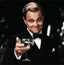 a six-panel gif shows leonardo dicaprio in a black tuxedo with a bow tie, holding a martini glass and smiling. In each…