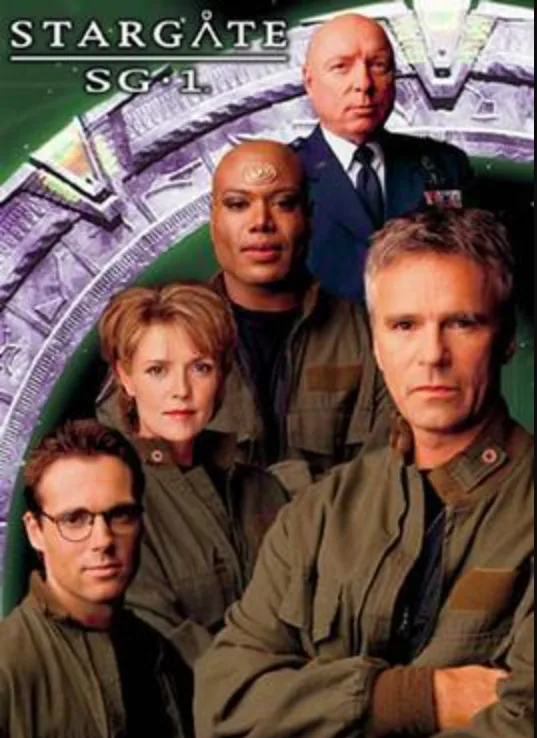 A promotional poster for the TV show 'Stargate SG-1' featuring five main characters standing in front of a large, glowing…