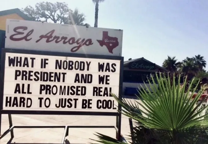 An outdoor photo of a restaurant sign for 'El Arroyo' in Austin, Texas, featuring a large marquee with black text on a white…