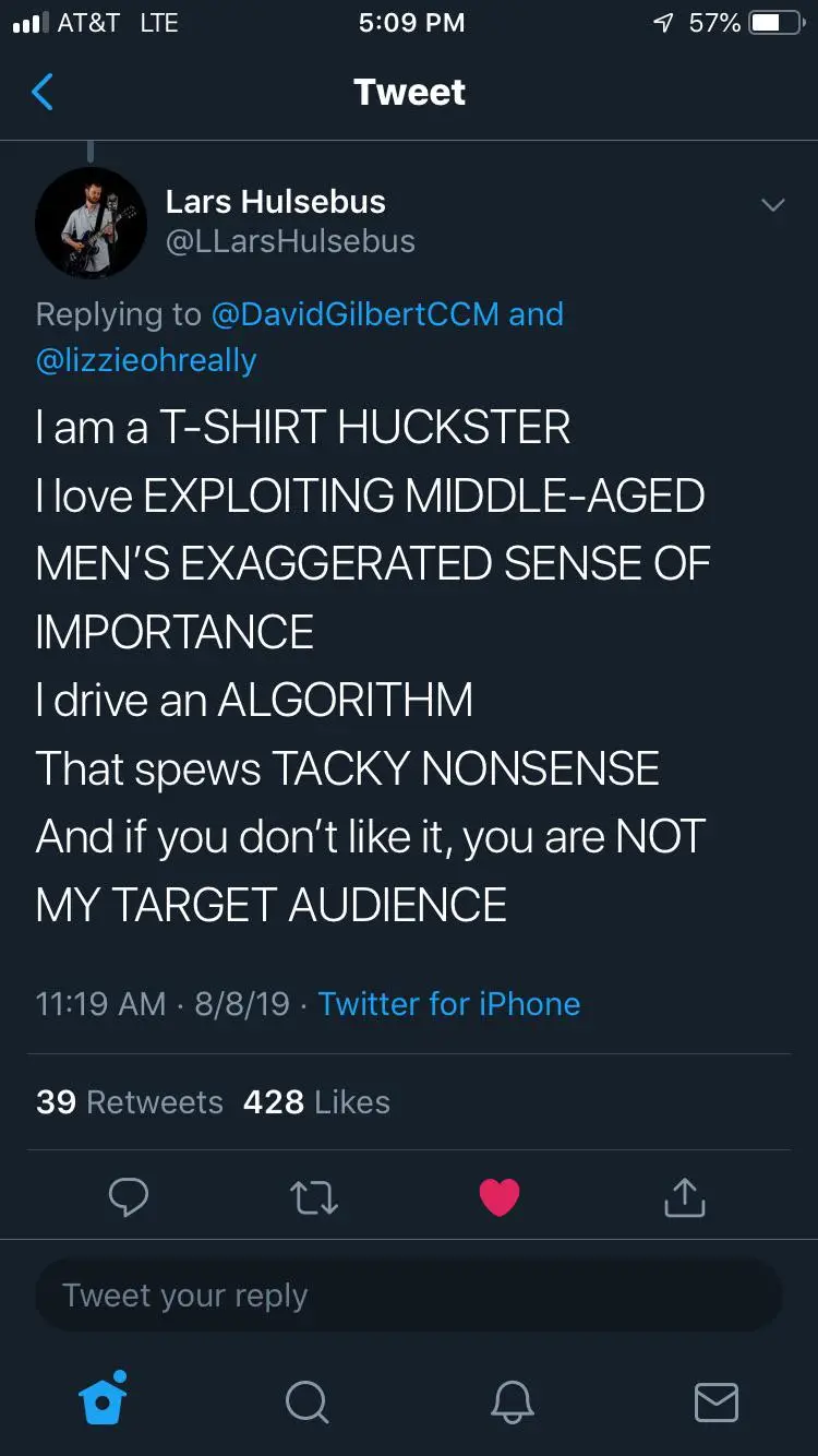 A screenshot of a tweet from Lars Hulsebus that reads: 'I am a T-SHIRT HUCKSTER I love EXPLOITING MIDDLE-AGED MEN'S…