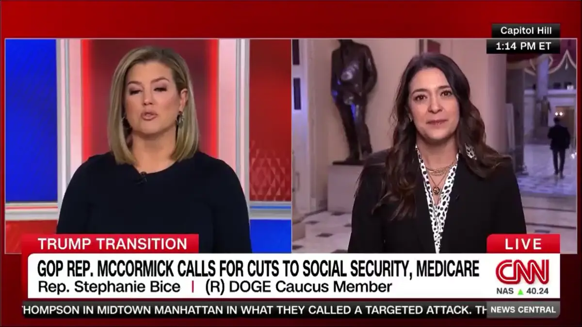 A split-screen CNN news broadcast shows two women in a live interview. The woman on the left, in a studio with red and blue…