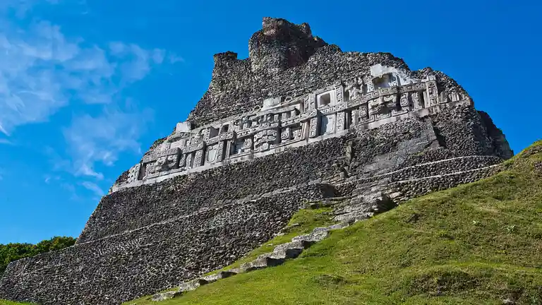 A haunting Maya archaeological complex, Xunantunich, lies on a plateau above the Mopan River in western Belize. Its name…