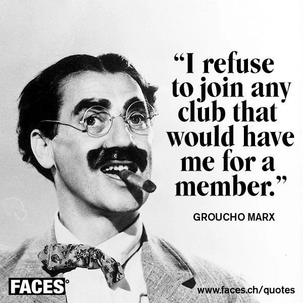A black-and-white photo of Groucho Marx smiling with a cigar in his mouth, wearing round glasses and a patterned bow tie…
