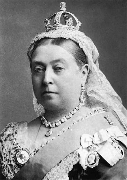 A formal black-and-white portrait of Queen Victoria wearing a crown, lace veil, and ornate jewelry. Overlaid text reads 'i…