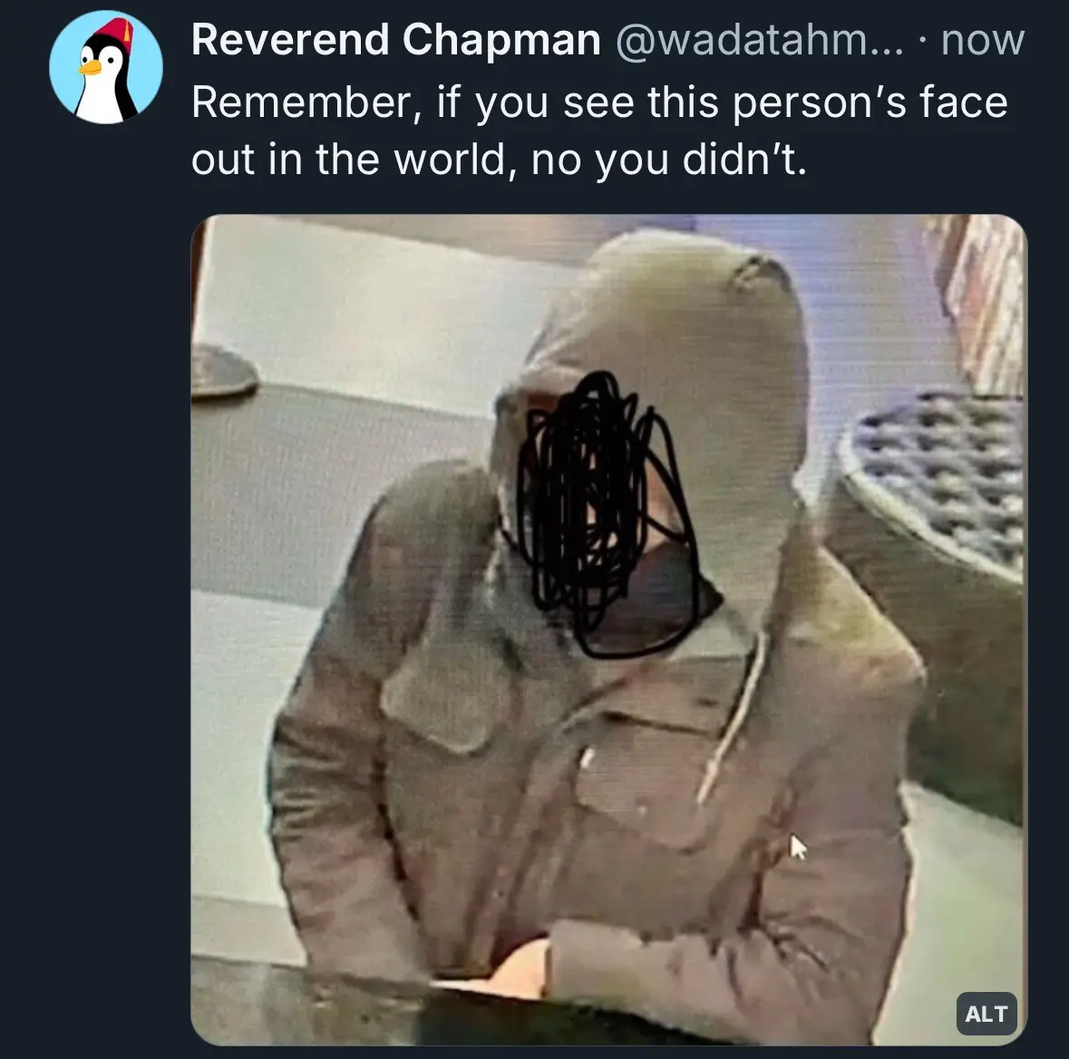 A low-resolution security camera image shows a person wearing a light-colored hooded jacket, seated at a table. Their face…