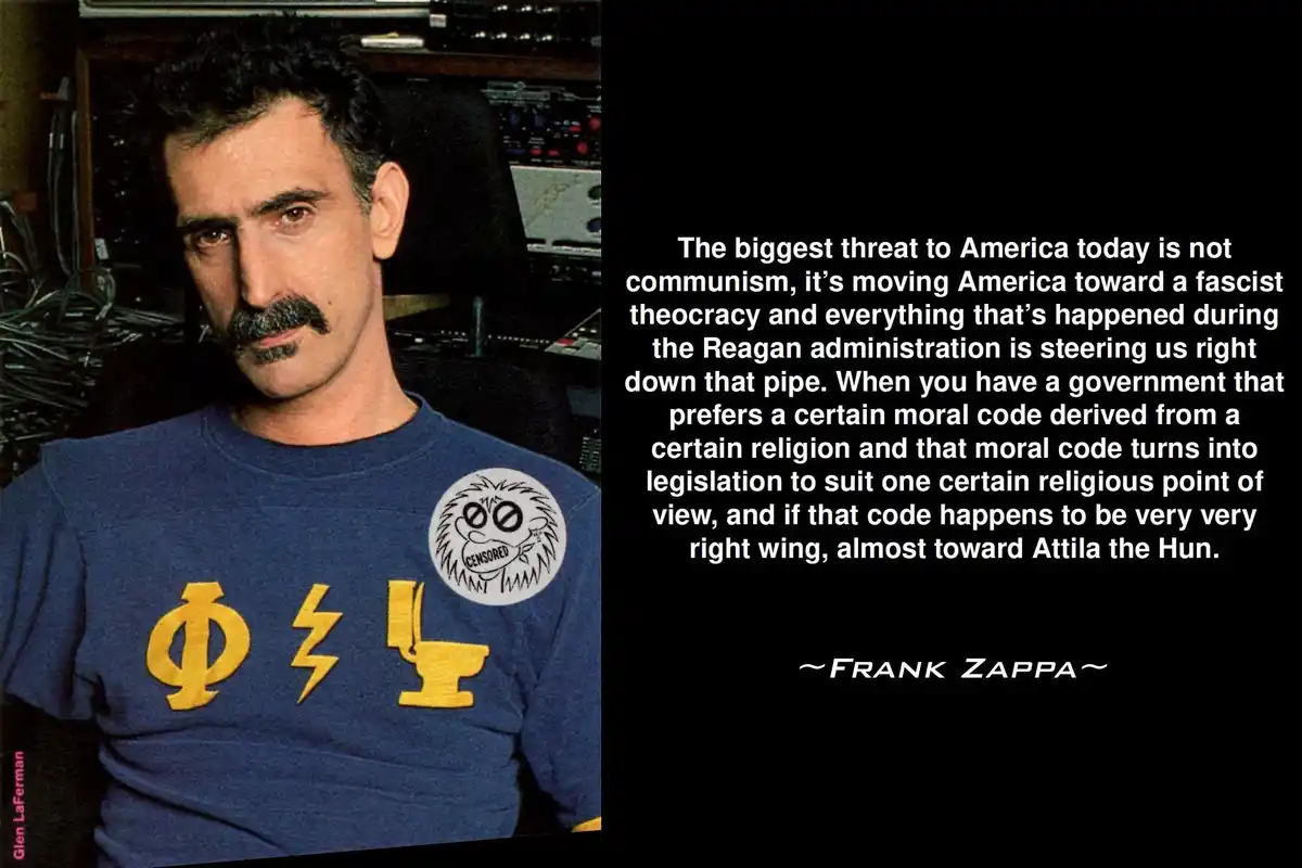 A photograph of Frank Zappa wearing a blue t-shirt with yellow symbols and a 'CENSORED' patch, set against a background of…