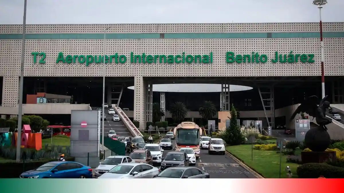 A wide shot of the T2 terminal of Benito Juárez International Airport in Mexico City, showing heavy traffic congestion with…