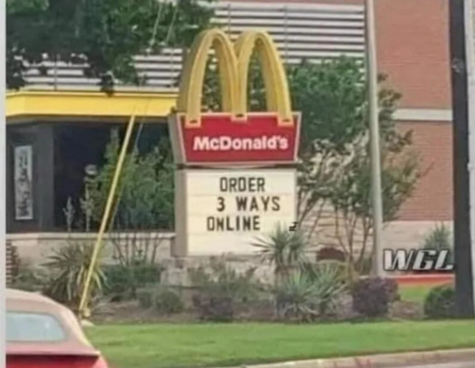 A McDonald's restaurant sign with its iconic golden arches and red logo, featuring a white marquee below that reads 'ORDER 3…
