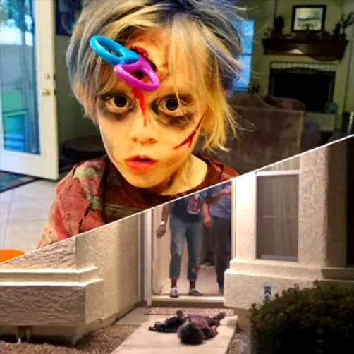 A young child with zombie makeup, including fake blood and a cut on the forehead, has two colorful plastic rings stuck to…