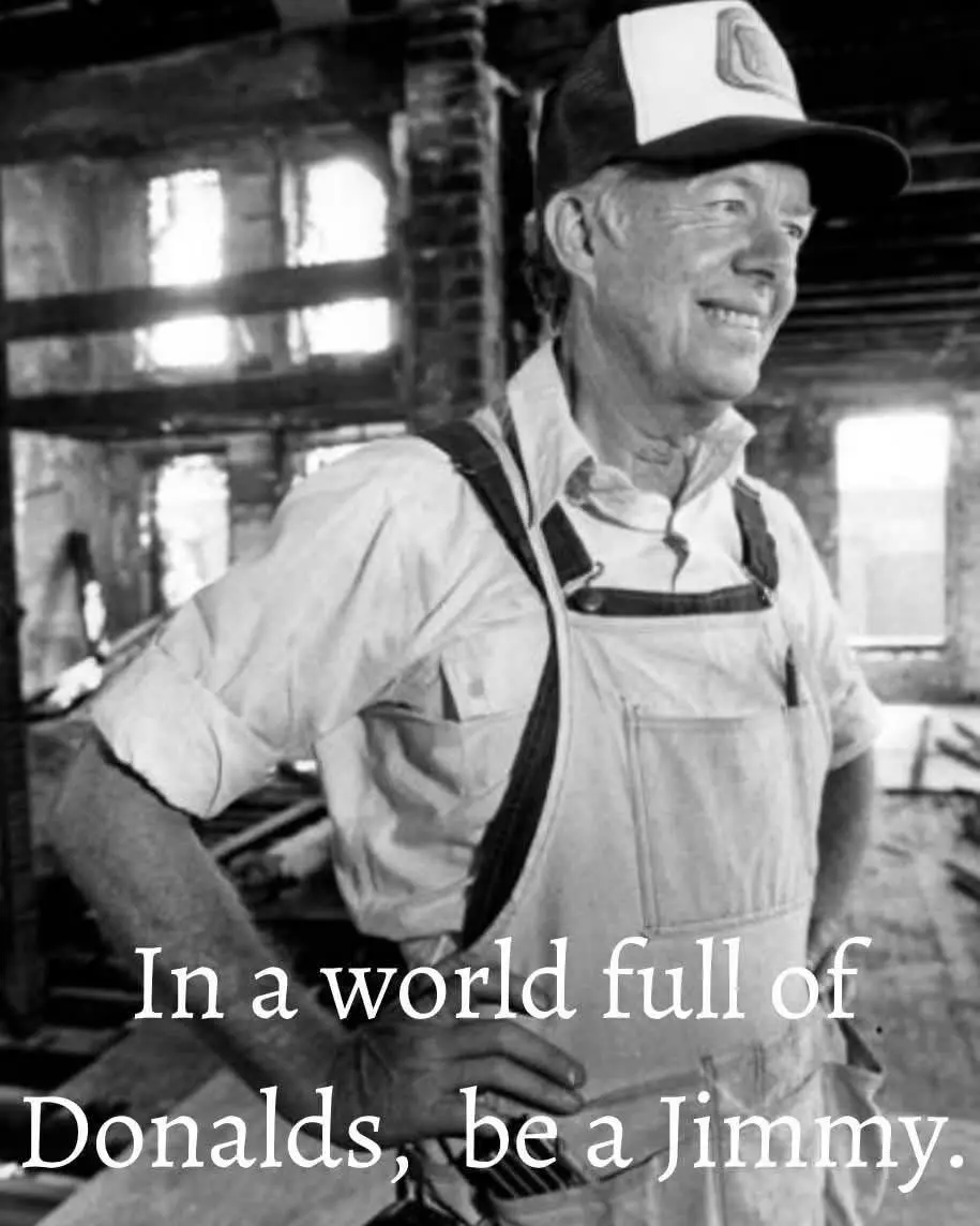 A black-and-white photo shows an older man wearing overalls and a baseball cap with a 'D' logo, standing confidently with…
