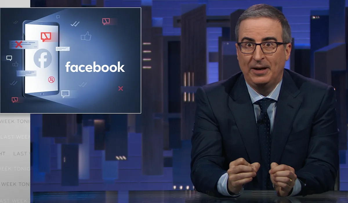 A man in a suit and glasses sits at a desk with a shocked expression, while a graphic of a smartphone displaying the…