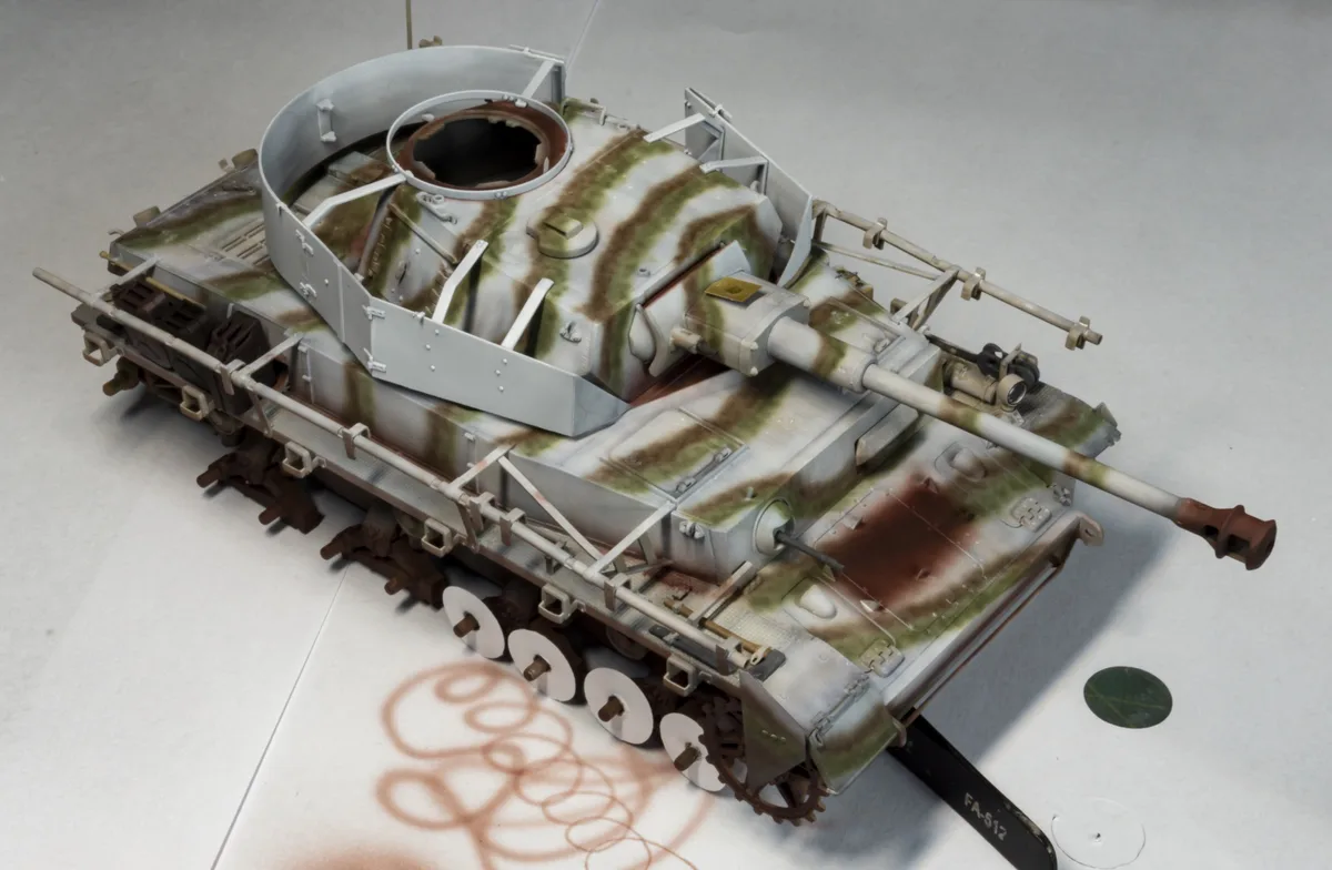 A highly detailed scale model of a German World War II tank, likely a Tiger I, is shown with its turret removed and placed…