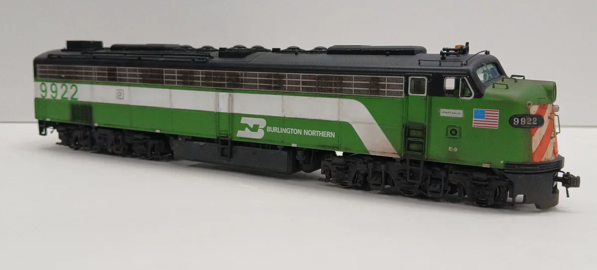 A detailed model of a Burlington Northern diesel locomotive, number 9922, painted in green and white livery with an American…