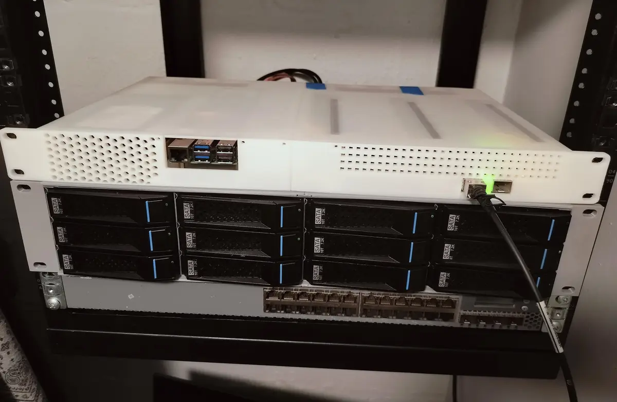 A white server rack unit with multiple black SATA hard drives stacked vertically, each labeled 'SATA 10T 7.2K'. The top unit…