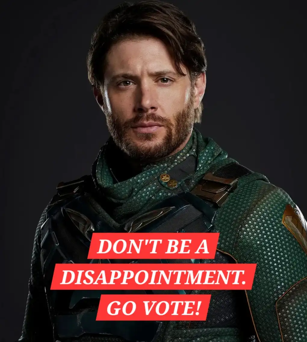 A man with a beard and dark hair, wearing a green and black armored outfit with star patterns, stares intensely at the…