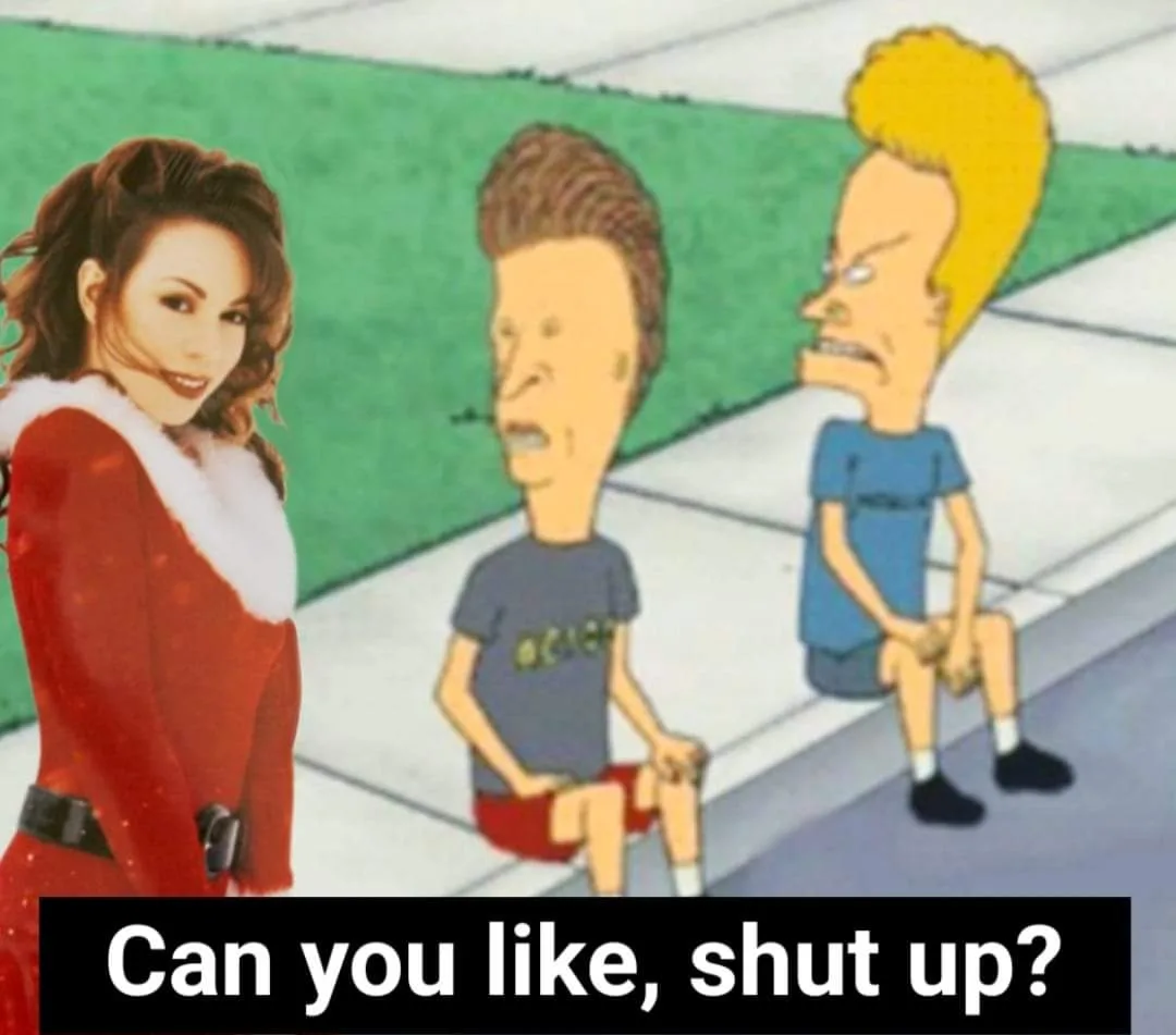 A woman in a red Santa-style outfit stands facing two cartoon characters from Beavis and Butt-Head who are sitting on a…