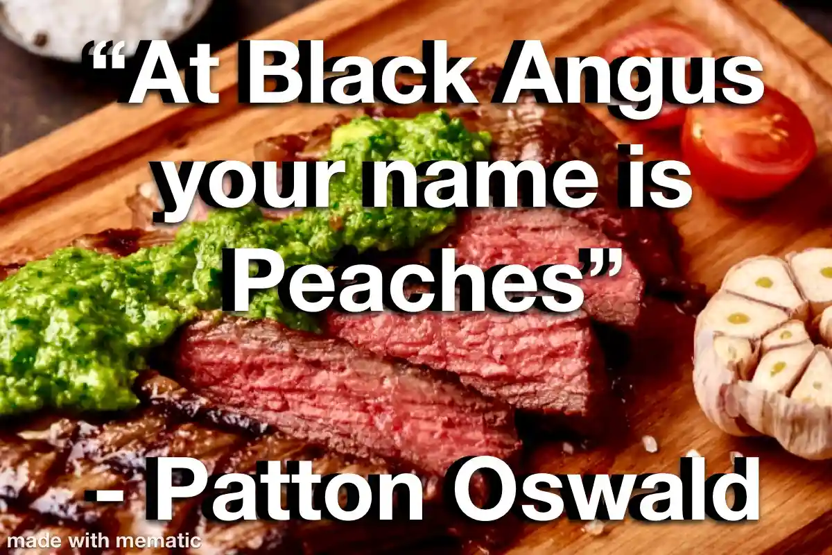 A close-up photo of sliced medium-rare steak on a wooden cutting board, topped with green pesto sauce, accompanied by halved…