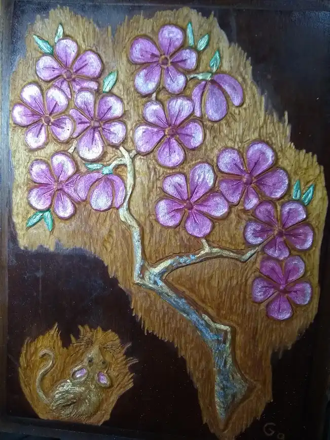 A textured, handmade artwork depicts a stylized tree with purple flowers and green leaves, set against a dark background. At…