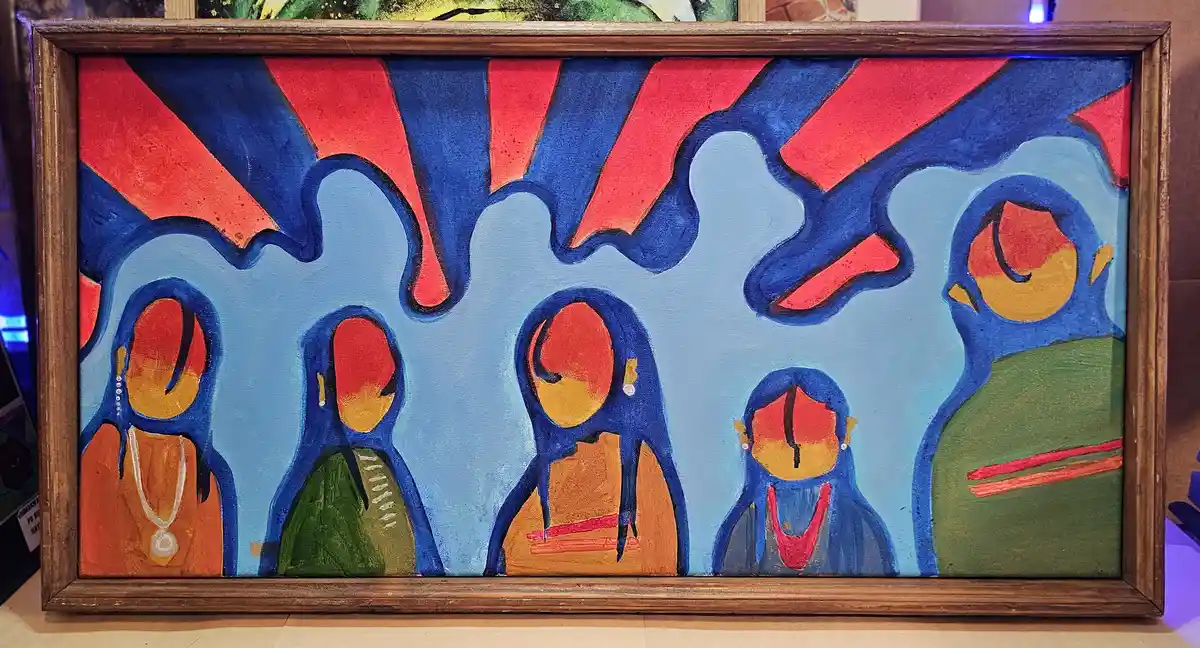 A framed abstract painting depicts five stylized human figures with blue outlines, orange-red faces, and colorful clothing…